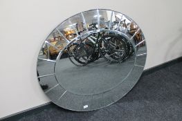 An all glass framed oval bevelled overmantel mirror