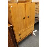 A double door light oak cabinet fitted with two drawers