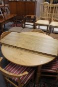 A mid century pull out teak dining table