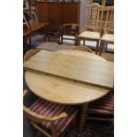 A mid century pull out teak dining table
