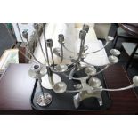 A pair of ornamental white metal candelabrum,