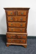 A reproduction eight drawer miniature chest