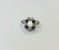 An antique 18ct sapphire and diamond horseshoe style ring