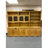 A three piece blonde oak bookcase