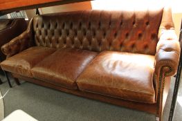 A brown buttoned leather three seater chesterfield style settee CONDITION REPORT: