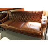 A brown buttoned leather three seater chesterfield style settee CONDITION REPORT: