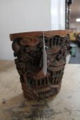 A late 19th century Chinese carved bamboo brush pot, intricately carved with figures and foliage,