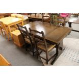 A traditional style oak pull out dining table and four chairs