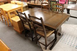 A traditional style oak pull out dining table and four chairs