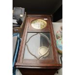 An early 20th century oak cased wall clock with silvered dial pendulum and key