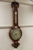 An early twentieth century carved oak barometer