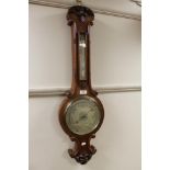 An early twentieth century carved oak barometer