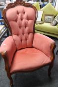 A reproduction Victorian style armchair in buttoned upholstery