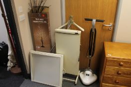 An electric trouser press, floor buffer, light box,