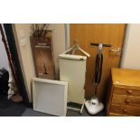 An electric trouser press, floor buffer, light box,