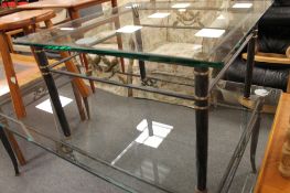 A glass and metal coffee table with matching lamp table