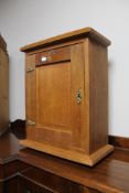 A small oak wall cabinet