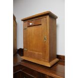 A small oak wall cabinet