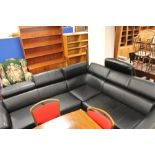 A black leather corner lounge suite