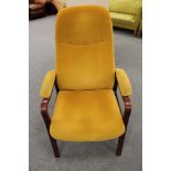 A stained beech framed armchair in mustard fabric