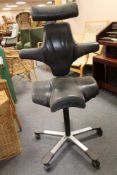 A mid century aluminium based black leather swivel chair