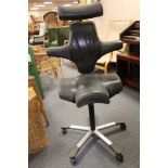 A mid century aluminium based black leather swivel chair