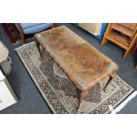 A walnut glass topped coffee table