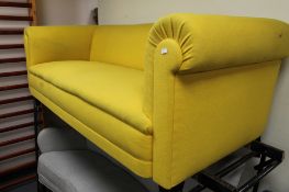 An early twentieth century yellow fabric three seater settee