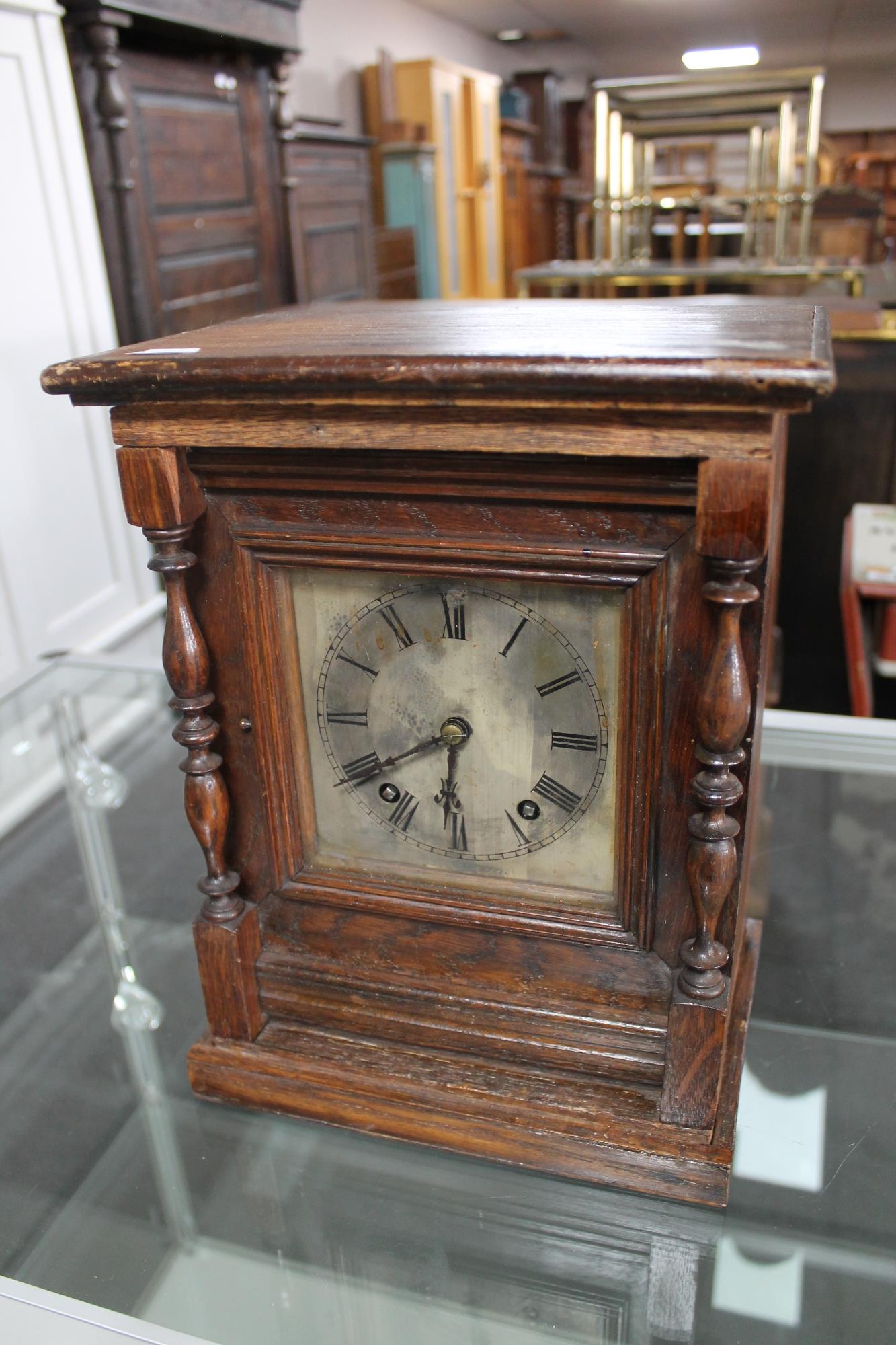 A continental oak cased bracket clock with silvered dial