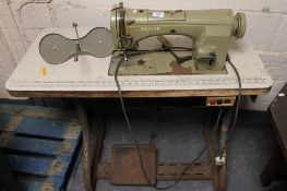 An industrial Necchi sewing machine in Singer table