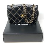A lady's Chanel black stitched leather chain shoulder bag,
