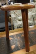 A small pine three legged stool and lamp table