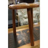 A small pine three legged stool and lamp table