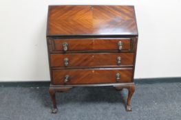 A reproduction mahogany bureau