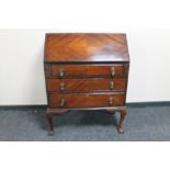 A reproduction mahogany bureau