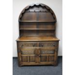 A carved oak dome topped dresser