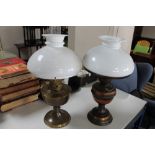 A pair of brass and white glass oil lamps