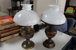 A pair of brass and white glass oil lamps