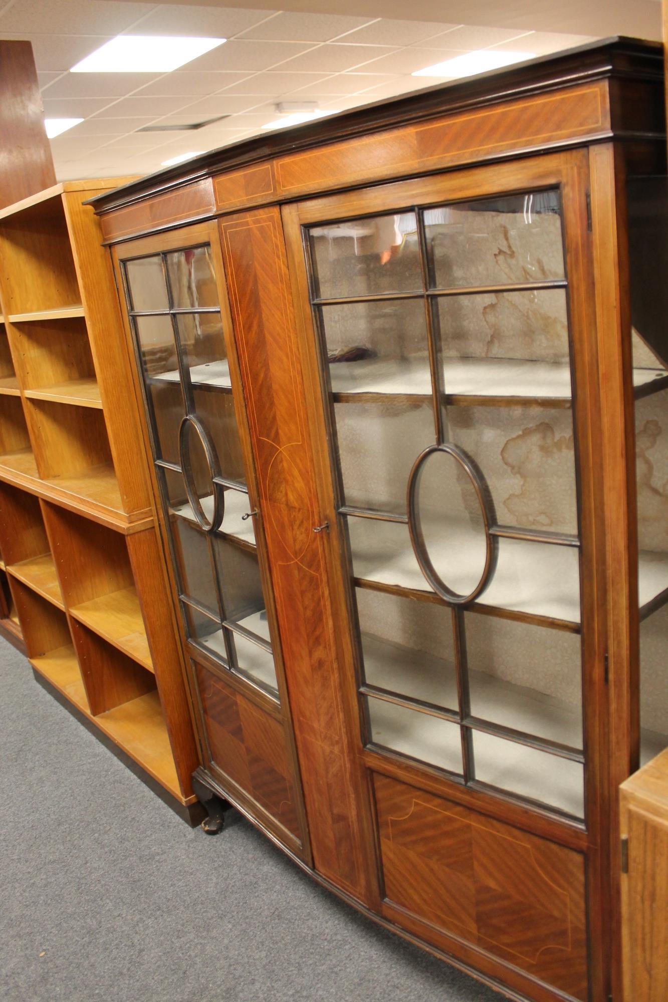An early twentieth century inlaid mahogany display cabinet