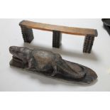 An African head rest together with a carving of an alligator