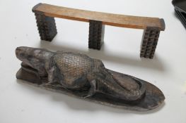 An African head rest together with a carving of an alligator