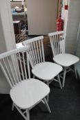 A set of three painted contemporary dining chairs