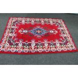 A woollen carpet of floral design,