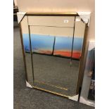 A gold-tone all glass mirror