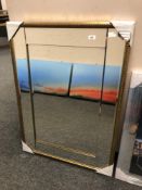 A gold-tone all glass mirror