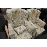 A pair of Edwardian armchairs with floral coverings