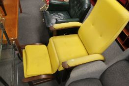 A contemporary armchair with matching footstool in yellow fabric