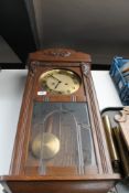 A 20th century oak cased Junghans 8 day wall clock with pendulum and key (glass a/f)