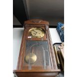 A 20th century oak cased Junghans 8 day wall clock with pendulum and key (glass a/f)