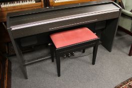An electric keyboard with stool and a ladder